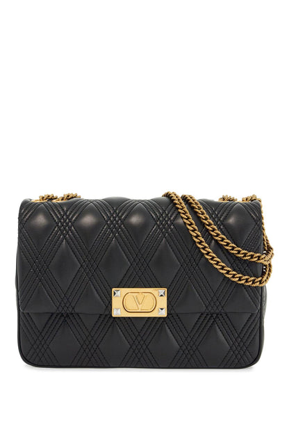 Quilted black shoulder bag with a gold chain