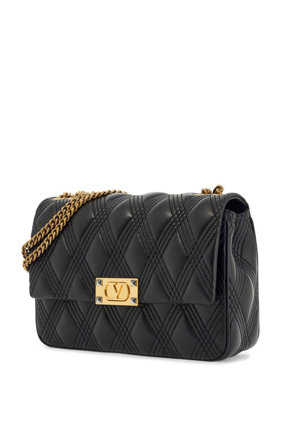 Quilted black shoulder bag with a gold chain